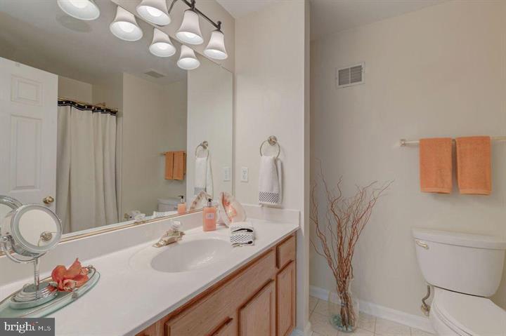 1618 South Taylor Street Arlington, VA 22204 - Photo 11 of 22 a bathroom with a sink vanity granite and toilet