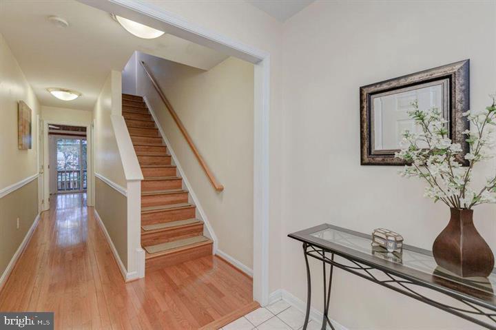 1618 South Taylor Street Arlington, VA 22204 - Photo 8 of 22 a view of a hallway with wooden floor and stairs