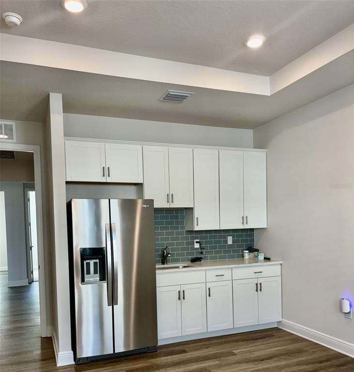 4307 Pullet Court Lakewood Ranch, FL 34211 - Photo 11 of 16 a kitchen with stainless steel appliances a refrigerator sink and cabinets