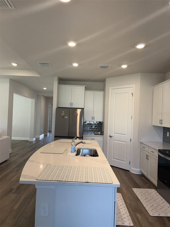 4307 Pullet Court Lakewood Ranch, FL 34211 - Photo 3 of 16 a kitchen with kitchen island sink stove and refrigerator