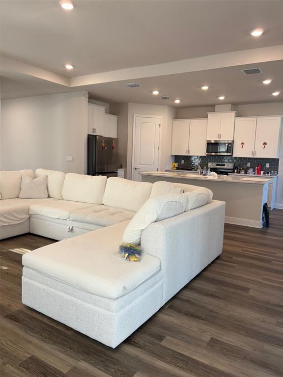 4307 Pullet Court Lakewood Ranch, FL 34211 - Photo 4 of 16 a living room with furniture and a wooden floor