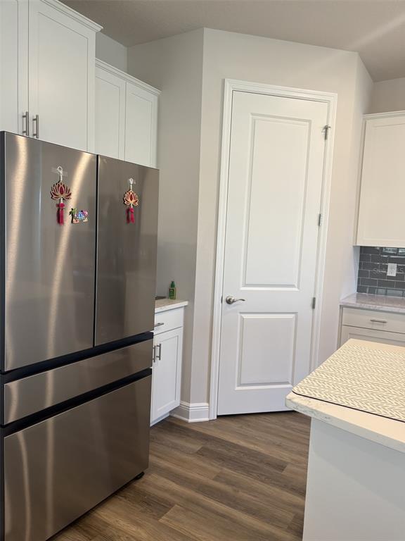 4307 Pullet Court Lakewood Ranch, FL 34211 - Photo 5 of 16 a view of a kitchen with refrigerator and wooden cabinets