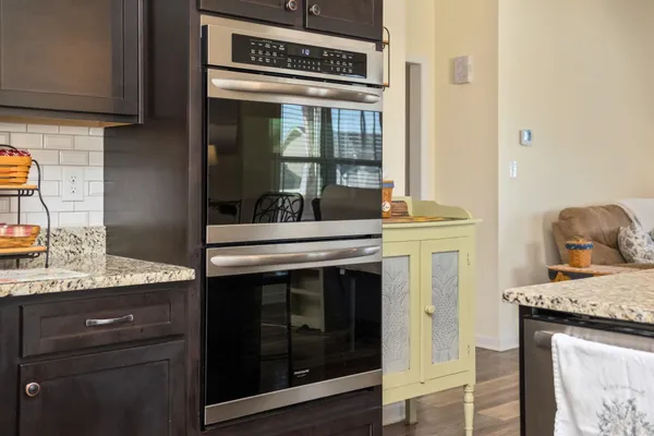 a kitchen with granite countertop cabinets stainless steel appliances and a counter space