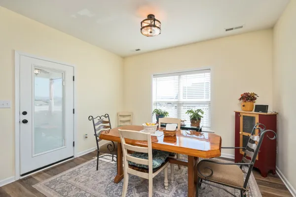 a dining room with furniture and window