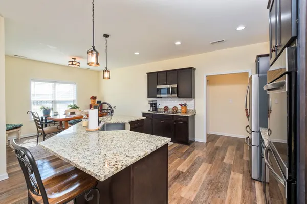 a kitchen with sink refrigerator and microwave