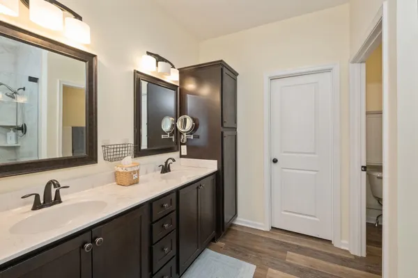 a bathroom with double vanity sinks and a mirror