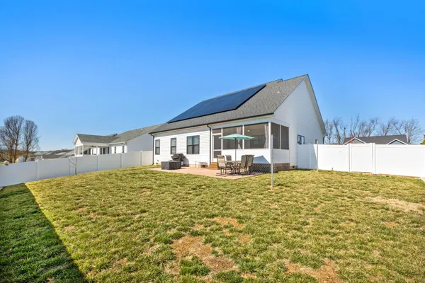 a house view with swimming pool in front of it