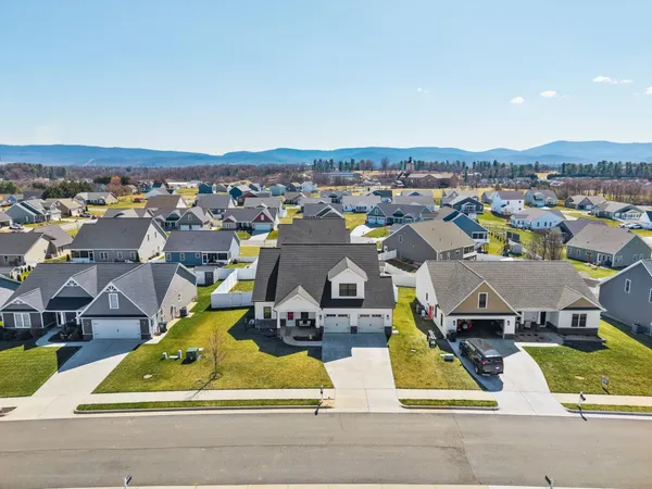 an aerial view of residential houses with yard