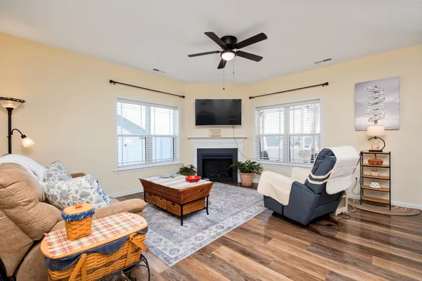 a living room with furniture a fireplace and a flat screen tv