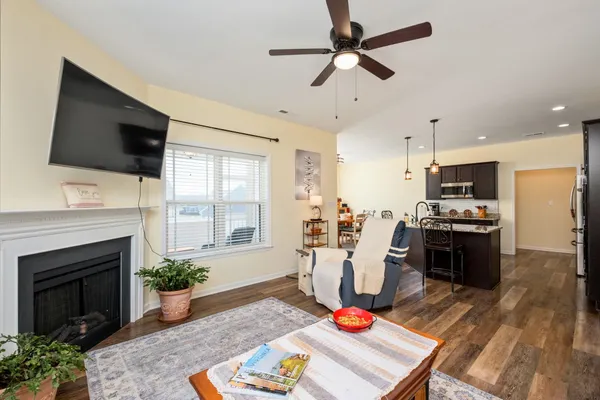 a living room with furniture fireplace and flat screen tv