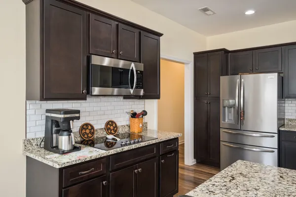a kitchen with a refrigerator sink and microwave
