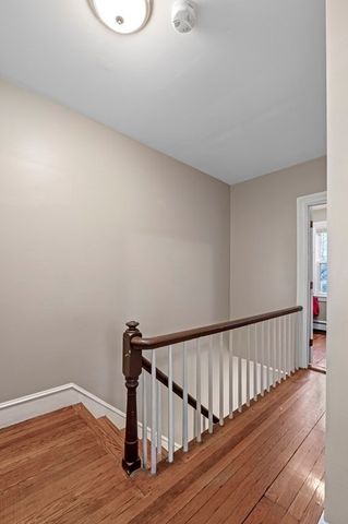a bedroom with a bed and a dresser next to a window