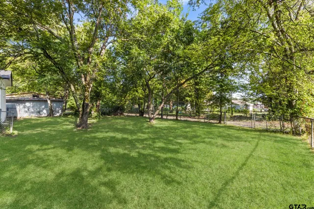 a huge green field with lots of trees