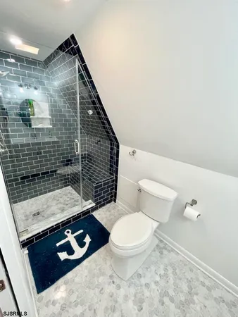 a bathroom with a toilet and a shower