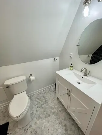 a bathroom with a sink toilet and mirror