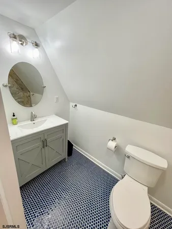 a bathroom with a toilet sink and mirror