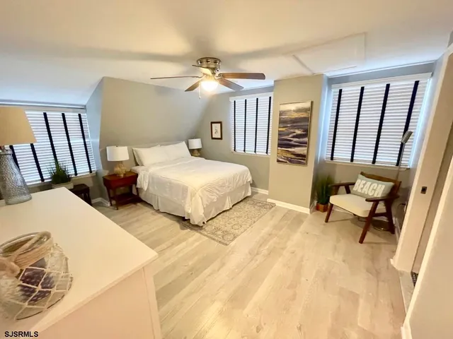 a bedroom with two beds and a dresser