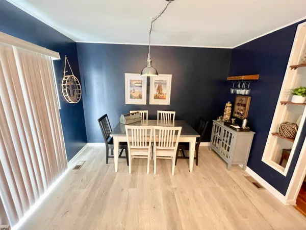a dining room with furniture and wooden floor