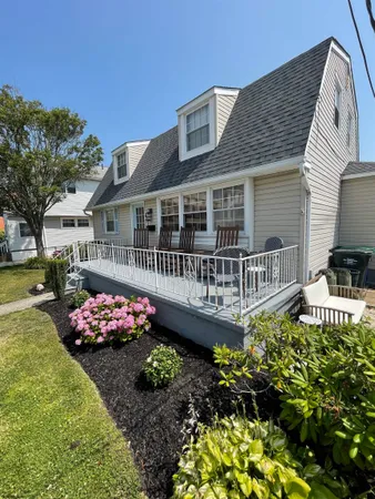 a front view of a house with a yard and fountain