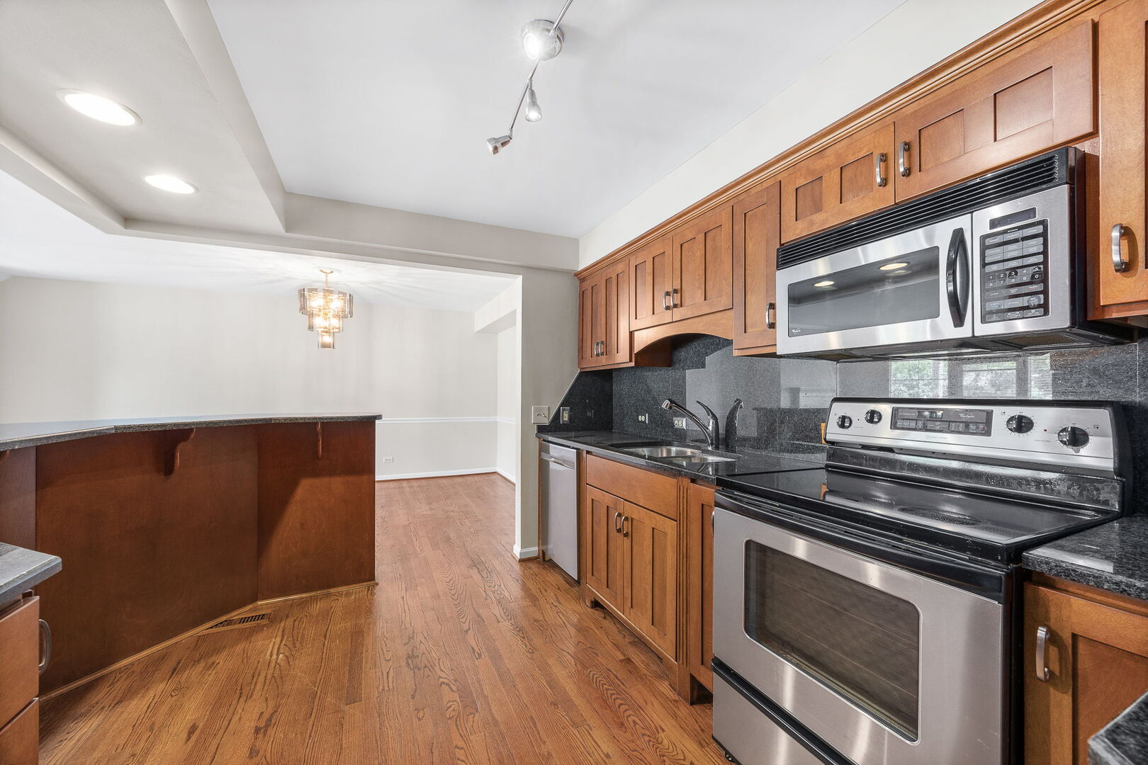 124 Carriage Way Drive, Unit B109 Burr Ridge, IL 60527 - Photo 10 of 31 a kitchen with stainless steel appliances granite countertop a stove and a sink