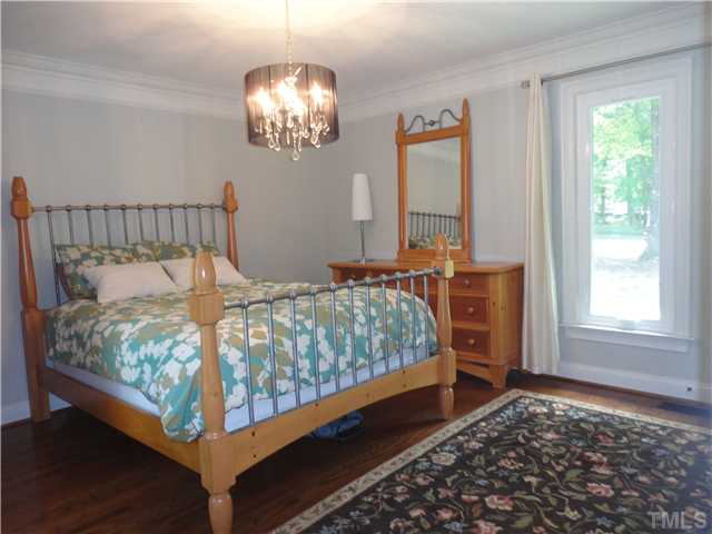 10232 Baileywick Road Raleigh, NC 27613 - Photo 17 of 24 a bed sitting in a bedroom next to a window