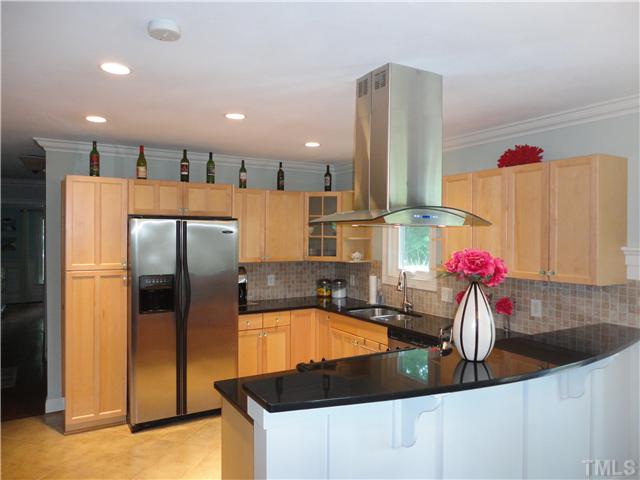 10232 Baileywick Road Raleigh, NC 27613 - Photo 3 of 24 a kitchen with stainless steel appliances granite countertop a sink refrigerator and cabinets
