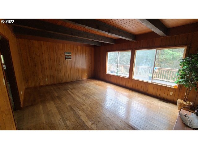 604 Thorton Oar Lane Reedsport, OR 97467 - Photo 12 of 32 a open hall with wooden floor and windows