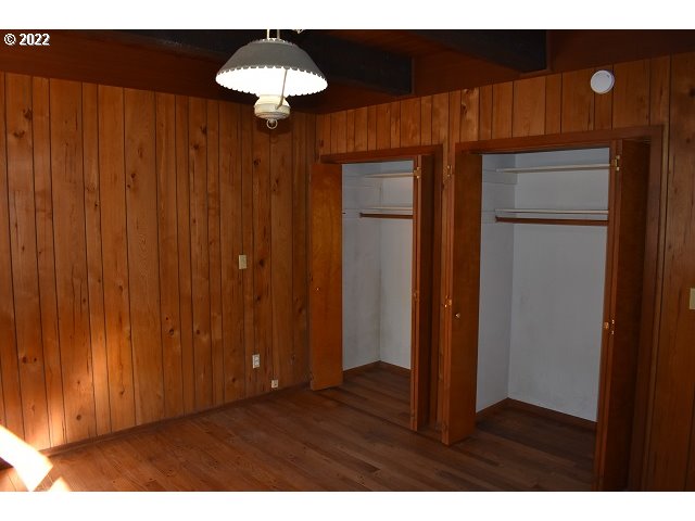 604 Thorton Oar Lane Reedsport, OR 97467 - Photo 22 of 32 a view of an empty room with a chandelier