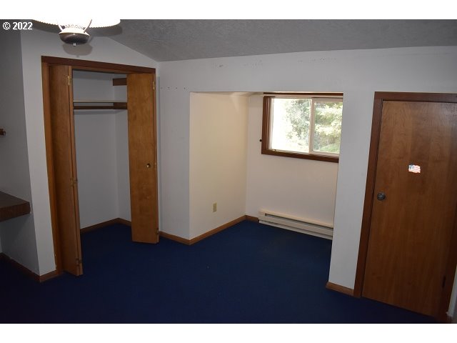 604 Thorton Oar Lane Reedsport, OR 97467 - Photo 27 of 32 a view of an empty room with wooden floor and closet