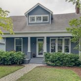 front view of a brick house with a yard
