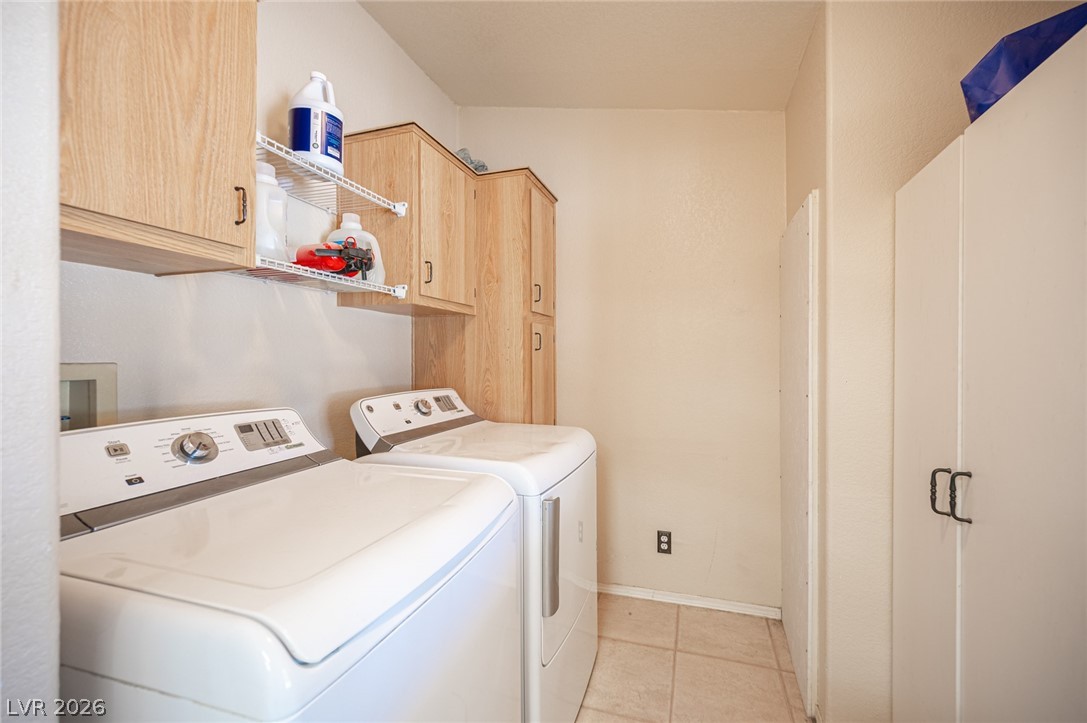 3200 Maple Road Pahrump, NV 89048 - Photo 40 of 53 Functional laundry space featuring modern appliances and ample storage cabinetry.