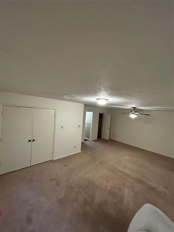 1302 Crescent Street Denton, TX 76201 - Photo 24 of 24 Below grade area featuring carpet flooring and a ceiling fan