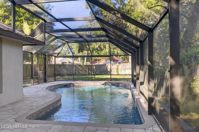 a view of an empty room with a fireplace and a window