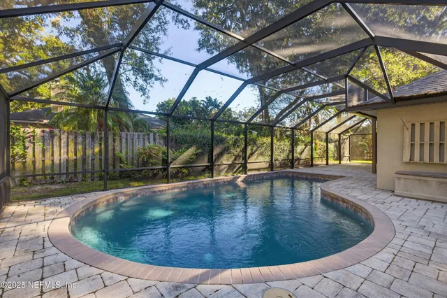 a bathroom with a tub sink double vanity and a shower