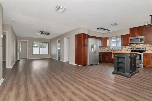 a view of kitchen with cabinets and wooden floor