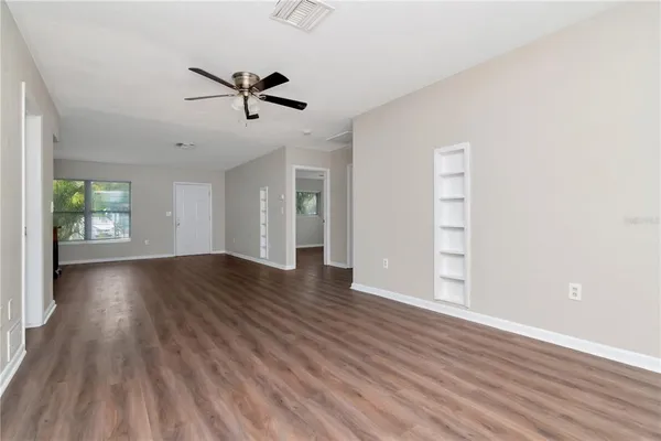 wooden floor in an empty room with a window