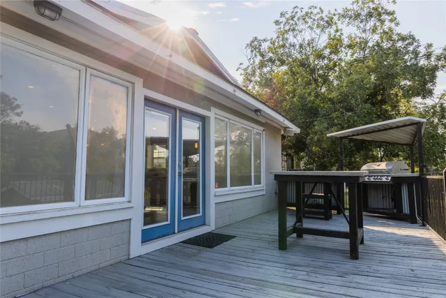 a view of house with deck and outdoor seating