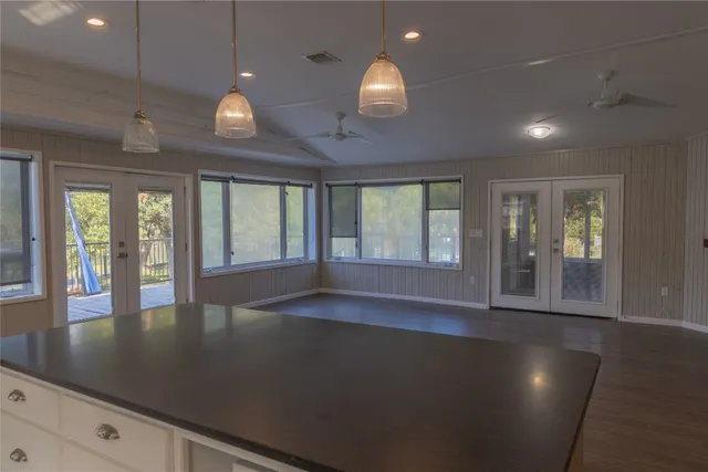 an open space with wooden floor and large window