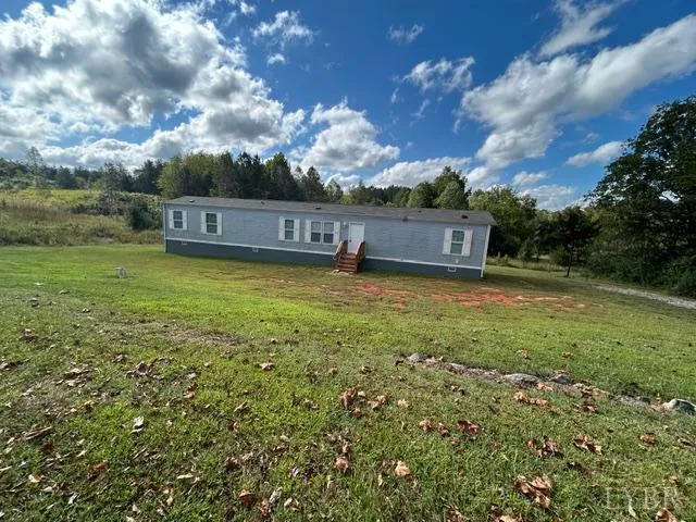 a view of a big yard with table and chairs and wooden fence