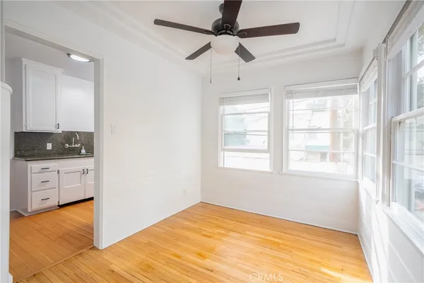 a view of an empty room with window and cabinet