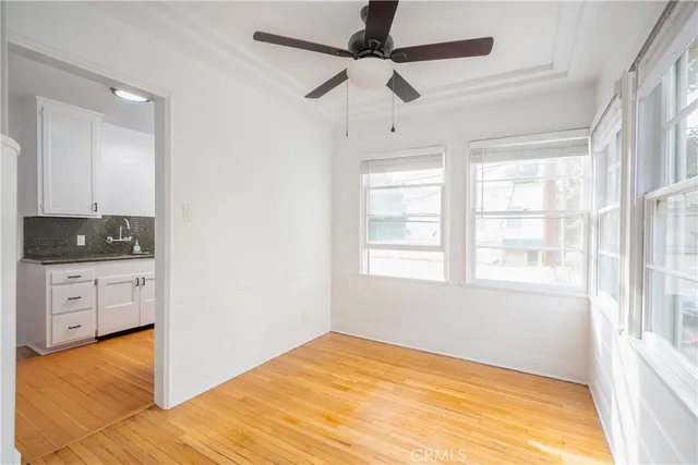 a view of an empty room with window and cabinet
