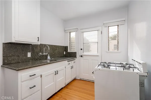 a kitchen with sink and cabinets