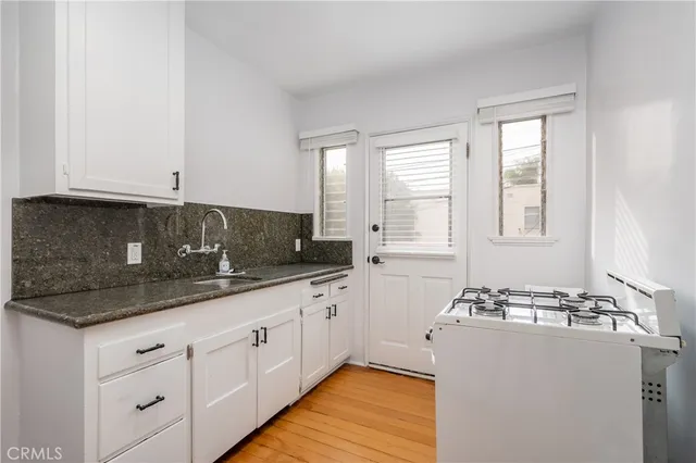 a kitchen with sink and cabinets