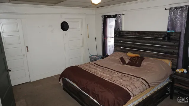 a bedroom with a bed and a window