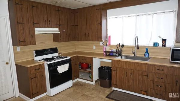 a kitchen with stainless steel appliances a stove a sink and a microwave