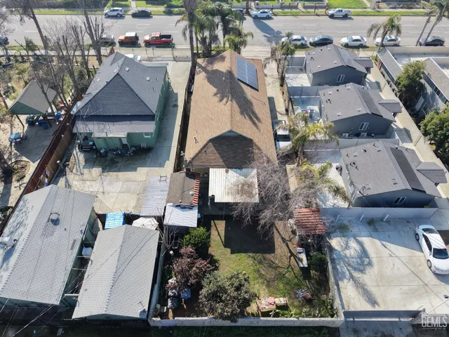 an aerial view of multiple houses with a yard