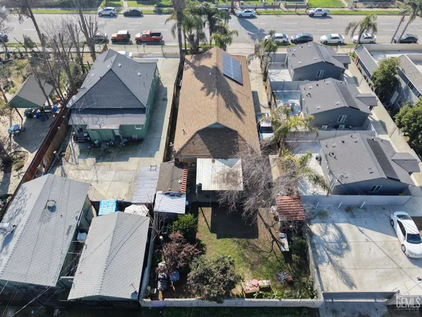 an aerial view of multiple houses with a yard
