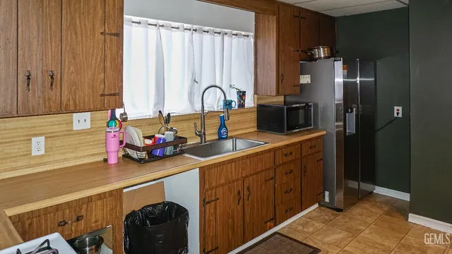 a kitchen with a sink and a refrigerator