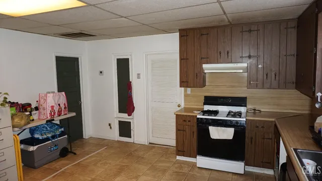a kitchen with stainless steel appliances granite countertop a stove and a refrigerator