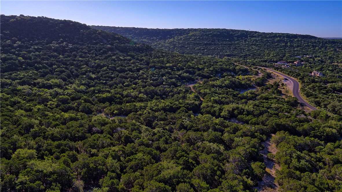 8267 Lime Creek Road Volente, TX 78641 - Photo 3 of 13 a view of a mountain in the distance